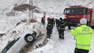 Karlı yolda kontrolden çıkan otomobil uçurumun yamacında asılı kaldı